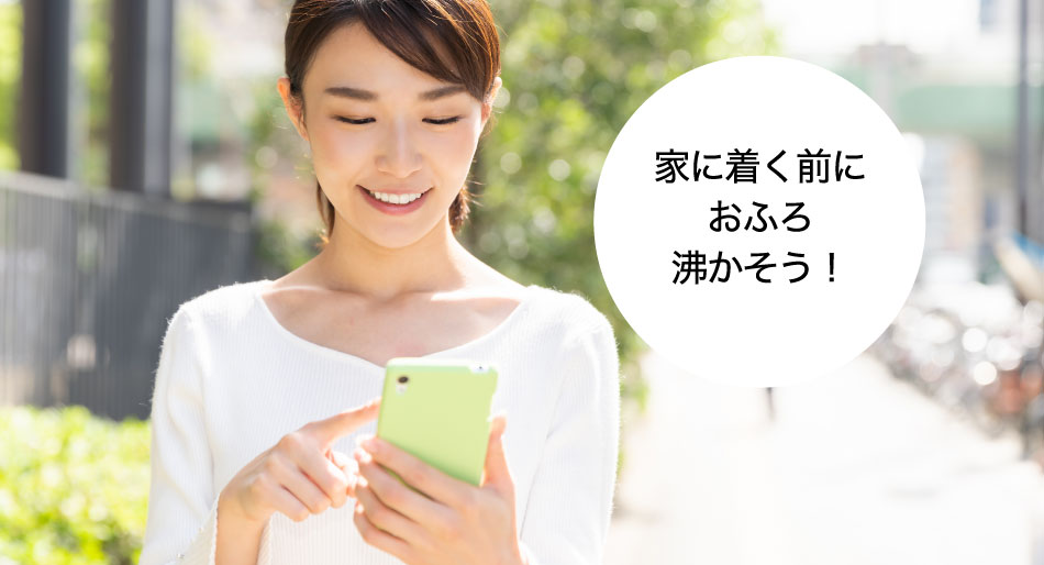 機器操作のイメージ画像です。「家につく前におふろを沸かそう!」と、女性がスマートフォンを操作している画像です。