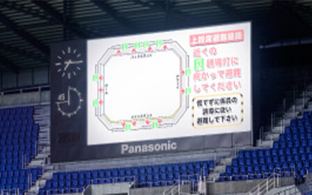 写真：スタジアム内の大型モニターに表示された避難経路